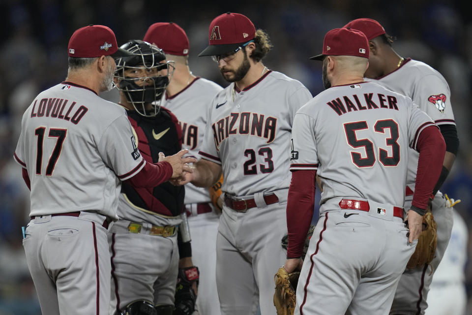 Arizona Diamondbacks manager Torey Lovullo (17) replaces starting pitcher Zac Gallen (23) during the sixth inning in Game 2 of a baseball NL Division Series against the Los Angeles Dodgers, Monday, Oct. 9, 2023, in Los Angeles. (AP Photo/Ashley Landis)