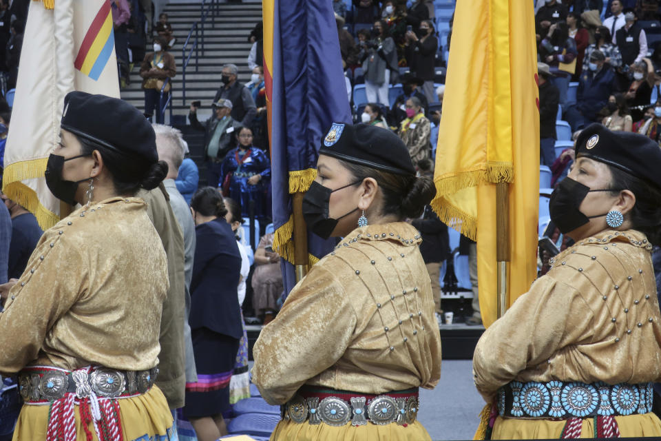 The Dine Saanii Silaoitsooi Color Guard, made up of all women, prepares to walk on stage for the Navajo Nation inauguration Tuesday, Jan. 10, 2023 in Fort Defiance, Ariz. Navajo President Buu Nygren is the youngest person elected to the position, while Vice President Richelle Montoya is the first woman to hold that office. (AP Photo/Felicia Fonseca)