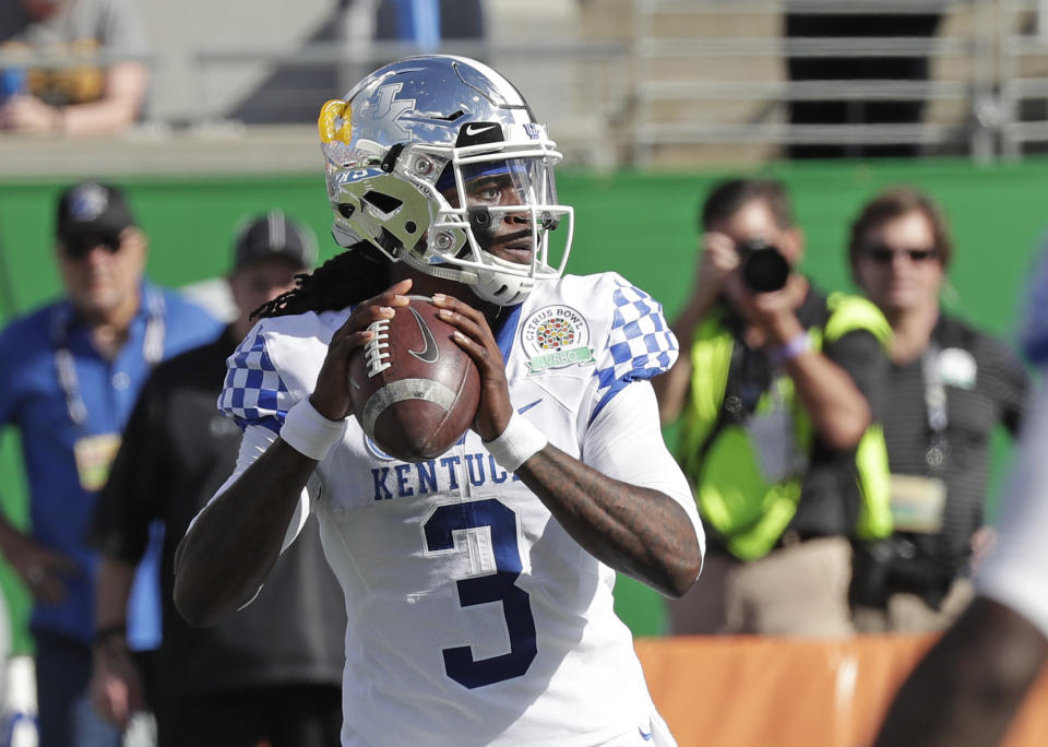 Kentucky quarterback Terry Wilson (3) looks for a receiver against Penn State during the first half of the Citrus Bowl NCAA college football game, Tuesday, Jan. 1, 2019, in Orlando, Fla. (AP Photo/John Raoux)