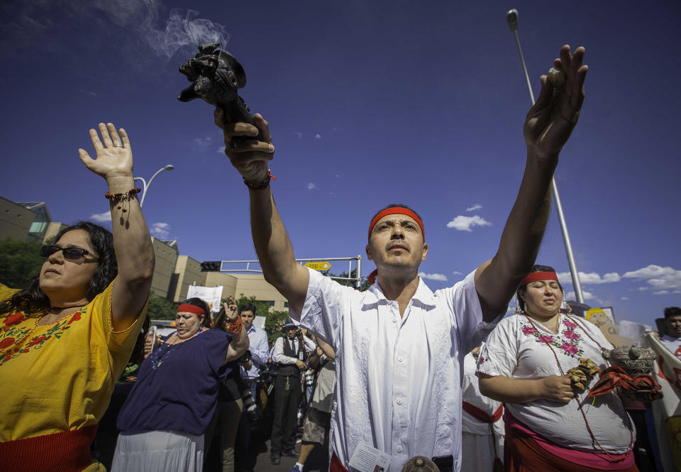 <p>A Native American religious ceremony is performed outside the Albuquerque Convention Center as part of a protest against the appearance of Republican presidential candidate Donald Trump, Tuesday, May 24, 2016, in Albuquerque, N.M. (Jett Loe/The Las Cruces Sun-News via AP) </p>