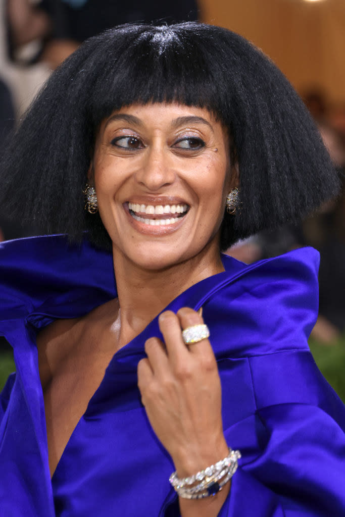 A close up of Tracee Ellis Ross as she smiles and poses while looking over her shoulder