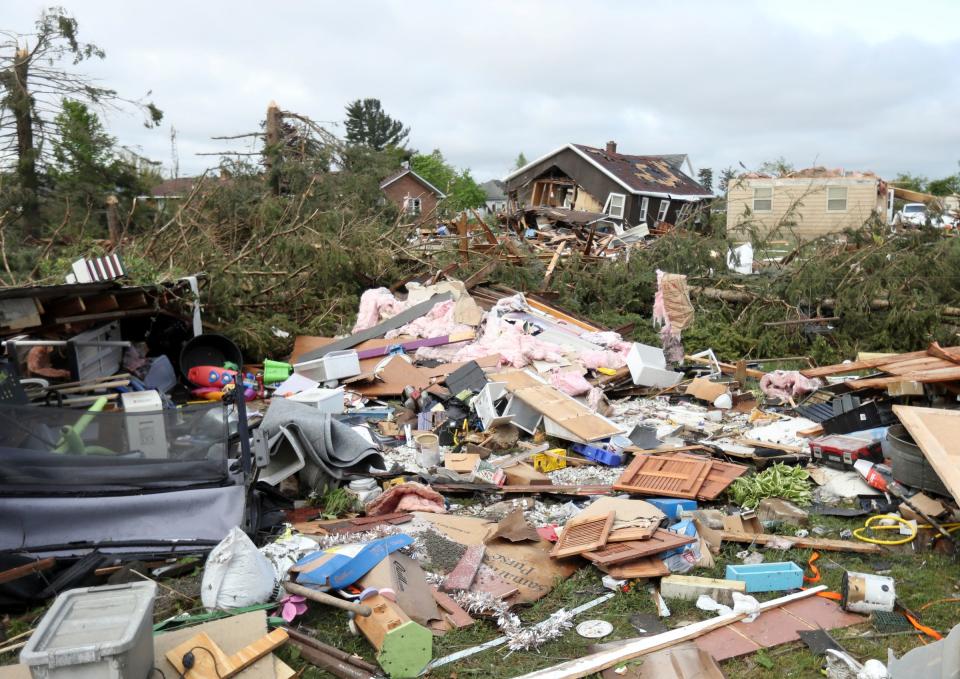 Residents of Gaylord assess damage after a tornado hit a section of the town Saturday, May 21, 2022.  The destroyed garage of the home owned by Steve and Theresa Haske  on Petoskey street.