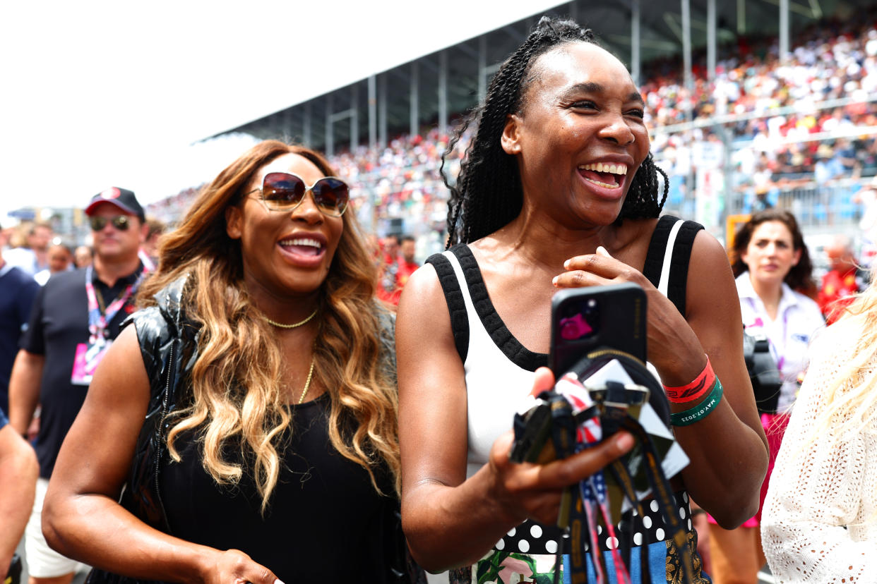 MIAMI, FLORIDA - MAY 07:  Venus Williams and Serena Williams laugh on the grid prior to the F1 Grand Prix of Miami at Miami International Autodrome on May 07, 2023 in Miami, Florida. (Photo by Dan Istitene - Formula 1/Formula 1 via Getty Images)
