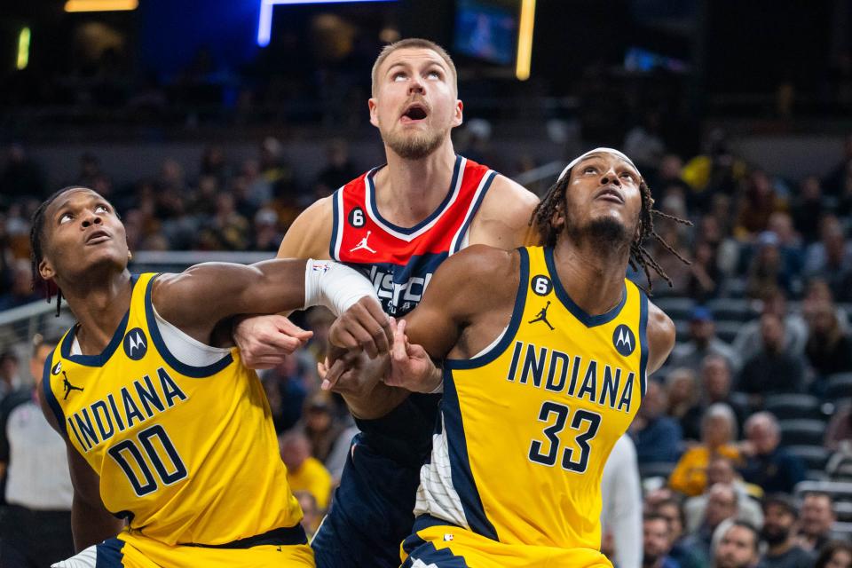 Dec 9, 2022; Indianapolis, Indiana, USA; Indiana Pacers guard Bennedict Mathurin (00) and center Myles Turner (33) box out Washington Wizards center Kristaps Porzingis (6) in the second half at Gainbridge Fieldhouse.