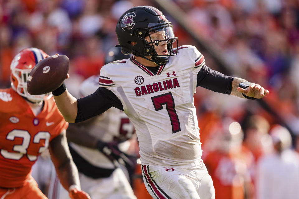 FILE - South Carolina quarterback Spencer Rattler (7) throws against Clemson during an NCAA college football game Nov. 26, 2022, in Clemson, S.C. Rattler needed answers before deciding on the NFL. He got all the right ones from his teammates and new offensive coordinator Dowell Loggains to stick around for another season. (AP Photo/Jacob Kupferman, File)