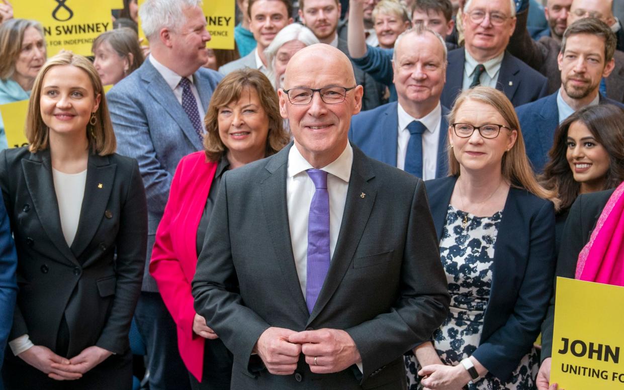 John Swinney poses with supporters at his leadership launch event in Edinburgh this morning