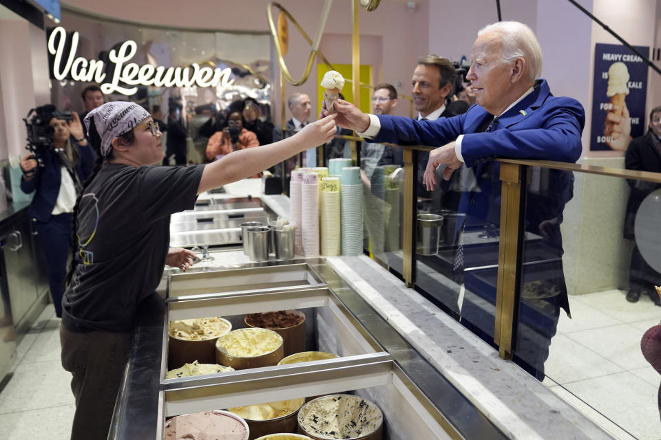 President Joe Biden gets an ice cream cone at Van Leeuwen Ice Cream Monday, Feb. 26, 2024, in New York, as Seth Meyers watches. (AP Photo/Evan Vucci)