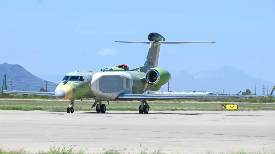 A picture of the initial EA-37B/EC-37B prior to the application of its overall gray paint scheme. The 'cheek' fairing on the left side of its fuselage is prominently visible. <em>USAF</em>