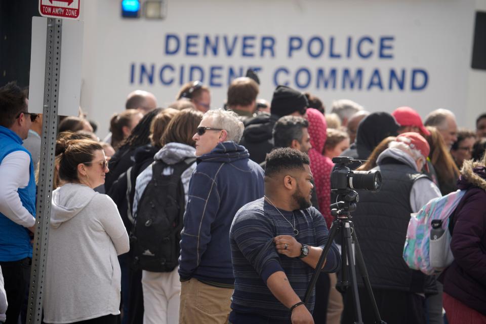 Parents wait for students to be walked out after two administrators shot and wounded after a handgun was found during a daily search of a student at Denver East High School Wednesday, March 22, 2023 (AP)