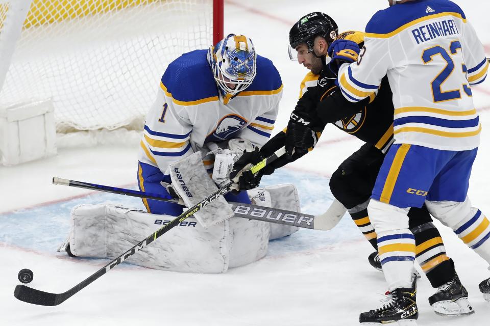 Boston Bruins' Patrice Bergeron (37) scores on Buffalo Sabres' Ukko-Pekka Luukkonen (1) during the second period of an NHL hockey game, Saturday, May 1, 2021, in Boston. (AP Photo/Michael Dwyer)