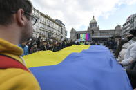 People with an Ukrainian flag protest against Russian invasion to Ukraine at the Wenceslaw square, in Prague, on Sunday, Feb. 27, 2022. (Michaela Rihova/CTK via AP) ** SLOVAKIA OUT **