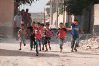 <p>Children flash victory signs as they play in Manbij, in Aleppo Governorate, Syria, Aug. 9, 2016. (REUTERS/Rodi Said) </p>