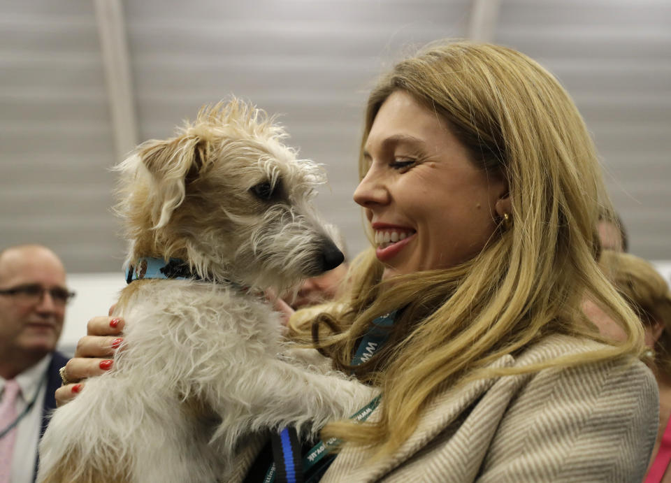 Carrie Symonds, the partner of Britain's Prime Minister and Conservative Party leader Boris Johnson holds their dog Dilyn after arriving for the Uxbridge and South Ruislip constituency count declaration at Brunel University in Uxbridge, London, Friday, Dec. 13, 2019. (AP Photo/Kirsty Wigglesworth)