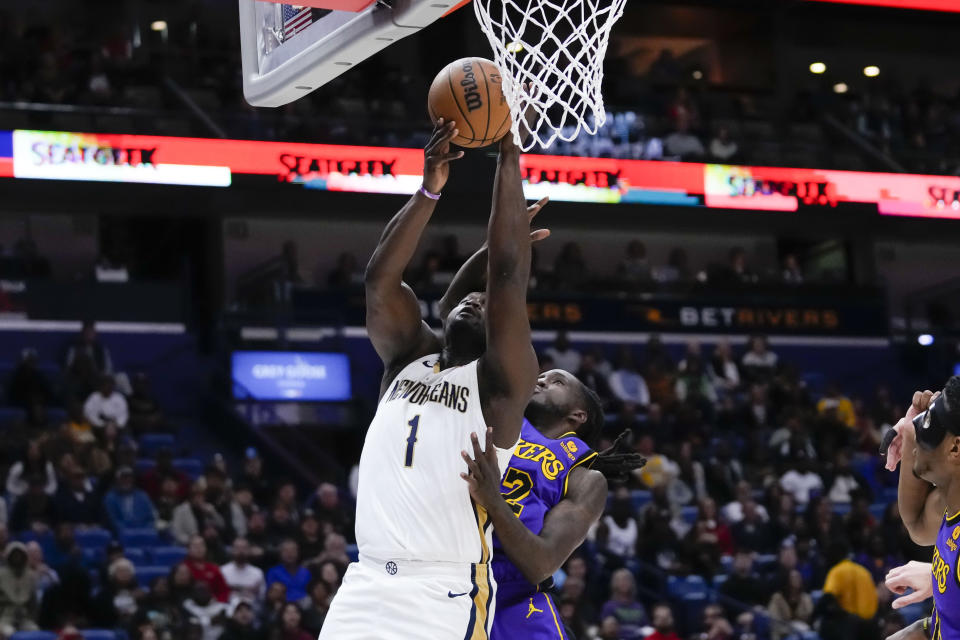 New Orleans Pelicans forward Zion Williamson (1) goes to the basket against Los Angeles Lakers forward Taurean Prince (12) in the first half of an NBA basketball game in New Orleans, Sunday, Dec. 31, 2023. (AP Photo/Gerald Herbert)