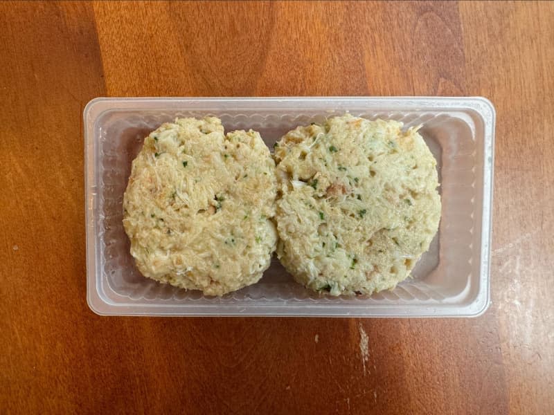 Crab cake in plastic packaging.