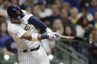 Milwaukee Brewers' Eduardo Escobar hits a two-run single during the third inning of a baseball game against the New York Mets Saturday, Sept. 25, 2021, in Milwaukee. (AP Photo/Aaron Gash)