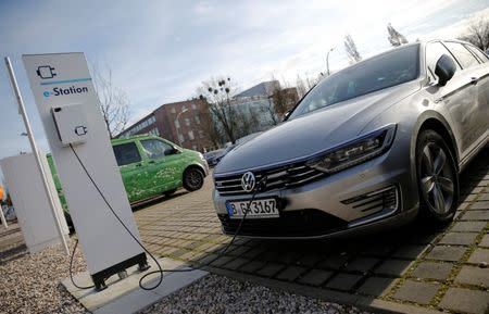 An electric Volkswagen Passat car is pictured at charging station at a VW dealer in Berlin, Germany, February 2, 2016. REUTERS/Fabrizio Bensch