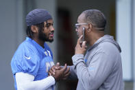 Detroit Lions running back D'Andre Swift greets team security director Elton Moore before drills at the Lions NFL football camp practice, Wednesday, July 28, 2021, in Allen Park, Mich. (AP Photo/Carlos Osorio)