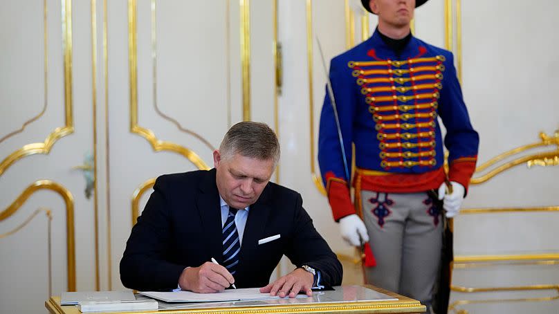 Newly appointed Slovakia's Prime Minister Robert Fico signs the oath during a swear in ceremony at the Presidential Palace in Bratislava, Slovakia