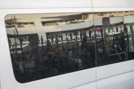 Relatives and journalists are reflected against the tinted windows of a police van taking Hajar Rissouni away from a court after she was sentenced to one year in prison on accusations of her undergoing an illegal abortion, in Rabat, Morocco, Monday, Sept. 30, 2019. The 28-year old Moroccan journalist Hajar Raissouni was sentenced to one year in prison, Monday, while her fiancé also received a one-year sentence and the doctor accused of terminating the pregnancy was sentenced to two years in jail and suspended from practicing. (AP Photo/Mosa'ab Elshamy)