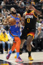 Oklahoma City Thunder forward Kenrich Williams (34) drives as Utah Jazz forward Eric Paschall (0) defends during the first half of an NBA basketball game Wednesday, Oct. 20, 2021, in Salt Lake City. (AP Photo/Rick Bowmer)