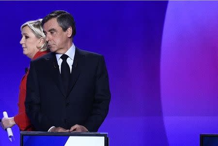 Francois Fillon, member of the Republicans political party and 2017 presidential election candidate of the French centre-right (R), and Marine Le Pen, French National Front (FN) political party leader and candidate, attend the France 2 television special prime time political show, "15min to Convince" in Saint-Cloud, near Paris, France, April 20, 2017. REUTERS/Martin Bureau/Pool