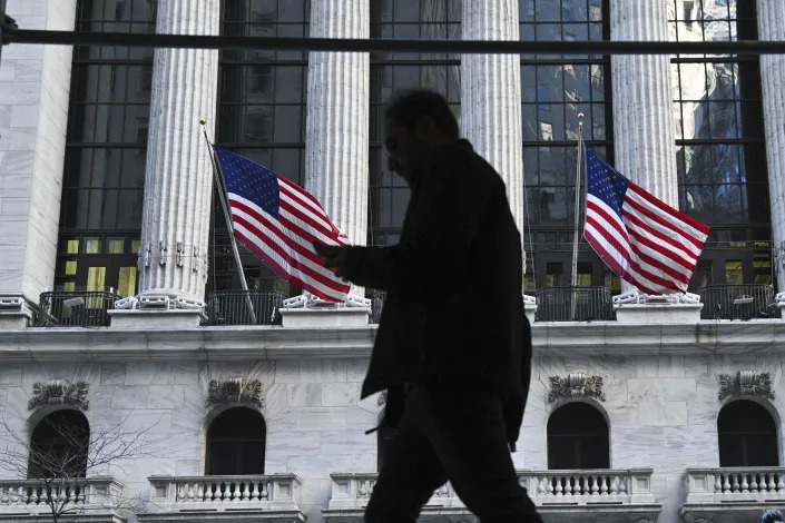 Photo by: NDZ/STAR MAX/IPx 2022 2/11/22 People walk past the New York Stock Exchange (NYSE) on Wall Street on February 11, 2022 in New York.