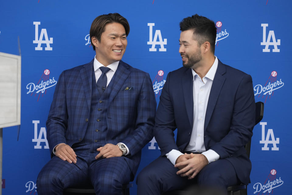 Yoshinobu Yamamoto, left, was officially introduced by the Dodgers on Wednesday after he signed a record 12-year, $325 million deal with the team.