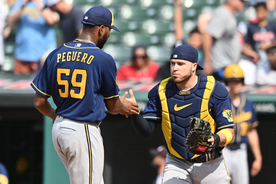 Brewers relief pitcher Elvis Peguero celebrates with catcher Victor Caratini after picking up his first save June 25 against the Guardians.