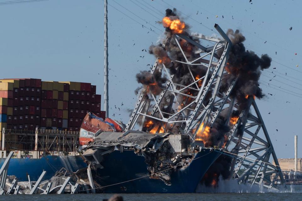 Explosive charges are detonated to bring down sections of the collapsed Francis Scott Key Bridge resting on the container ship Dali on Monday, May 13, 2024, in Baltimore (AP)