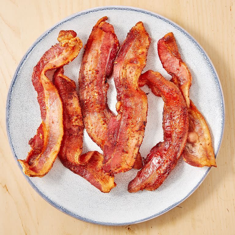 <p><a href="https://www.delish.com/uk/cooking/recipes/a30208165/how-to-cook-bacon-in-the-oven-recipe/" rel="nofollow noopener" target="_blank" data-ylk="slk:Cooking bacon in the oven;elm:context_link;itc:0;sec:content-canvas" class="link ">Cooking bacon in the oven</a> is the classic move, and it's a great one, but we are here to tell you to give the air fryer a chance. It will be done faster than your oven can preheat and we are always looking for faster ways to bacon! The air fryer makes the crispiest bacon of all time without all of the crazy amounts of grease. You'll love yourself for it. </p><p>Get the <a href="https://www.delish.com/uk/cooking/recipes/a31424224/air-fryer-bacon-recipe/" rel="nofollow noopener" target="_blank" data-ylk="slk:Crispy Air Fryer Bacon;elm:context_link;itc:0;sec:content-canvas" class="link ">Crispy Air Fryer Bacon</a> recipe.</p>