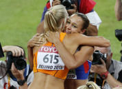 Jessica Ennis-Hill of Britain (R) is congratulated by Nadine Broersen of the Netherlands after completing the 800 metres to win the women's heptathlon at the IAAF World Championships at National Stadium in Beijing, China August 23, 2015. REUTERS/Fabrizio Bensch