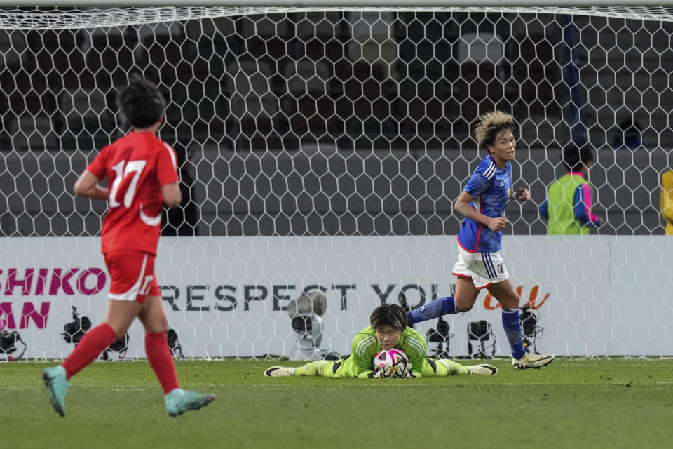 Japan's goalkeeper Ayaka Yamashita, lies on the ground after saving a goal during the final qualifier for the Paris Olympic women's football tournament at the National Stadium Wednesday, Feb. 28, 2024, in Tokyo. (AP Photo/Eugene Hoshiko)