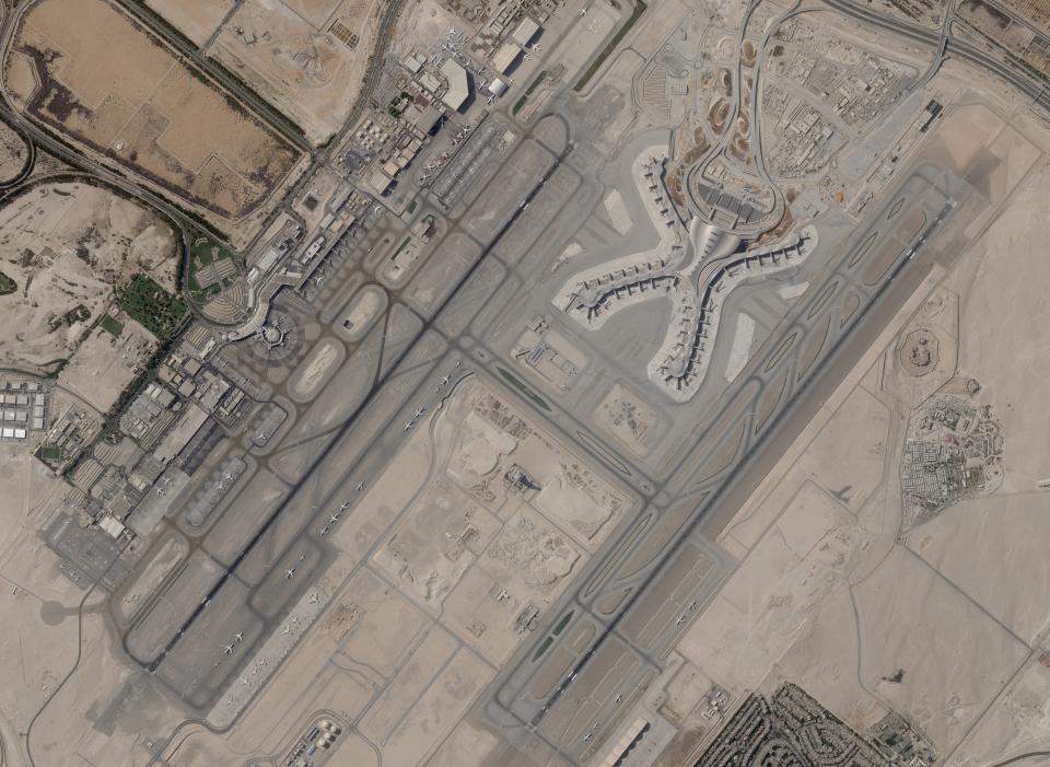 In a satellite photo by Planet Labs PBC, Abu Dhabi International Airport is seen Dec. 8, 2021. A suspected drone attack by Yemen's Houthi rebels targeting a key oil facility in Abu Dhabi killed three people and sparked a separate fire at Abu Dhabi's international airport on Monday, Jan. 17, 2022, police said. (Planet Labs PBC via AP)