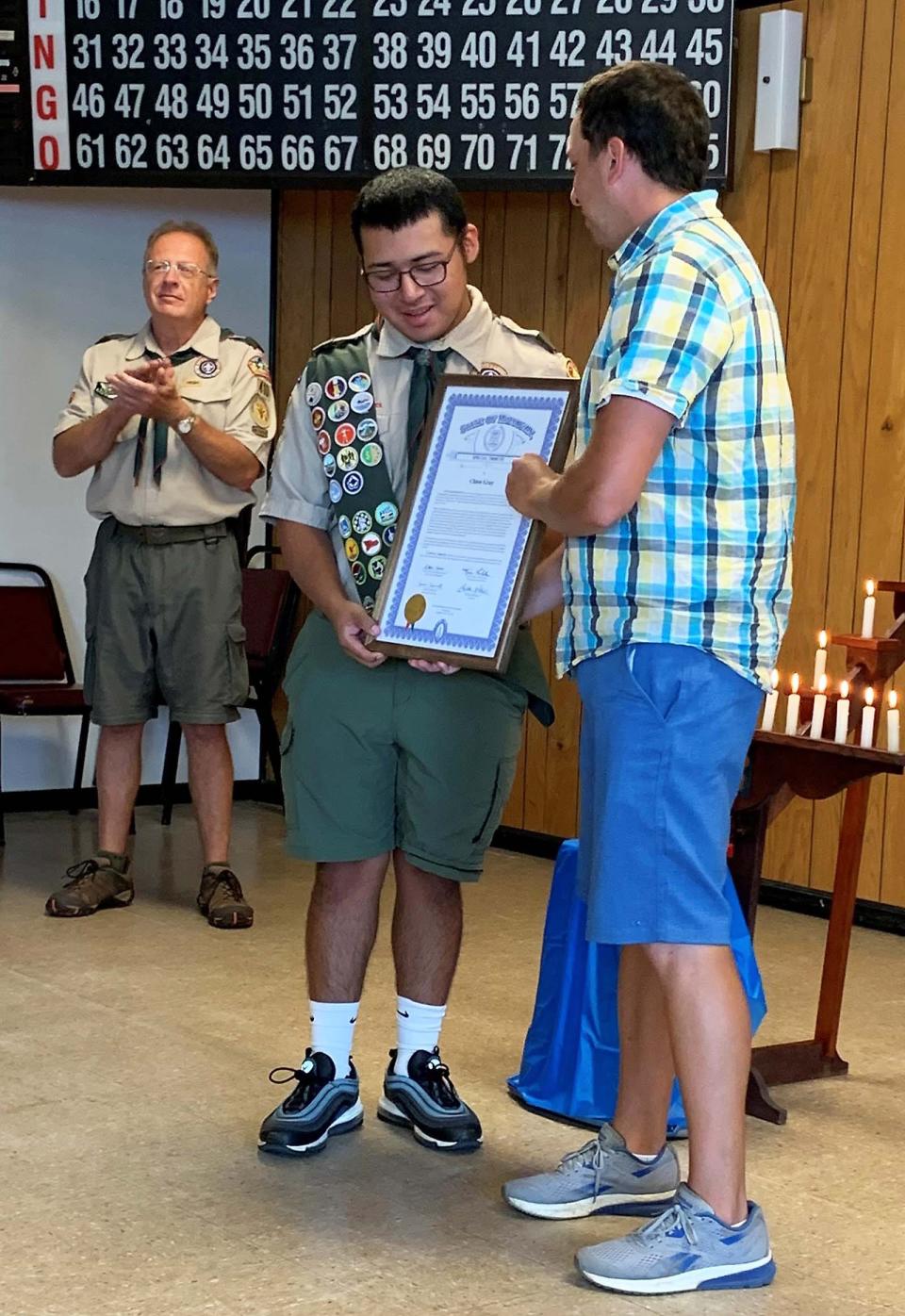 State Rep. Steve Carra presents Chase Gray with a special tribute signed by Carra, State Sen. Kim LaSata and Gov. Gretchen Whitmer.