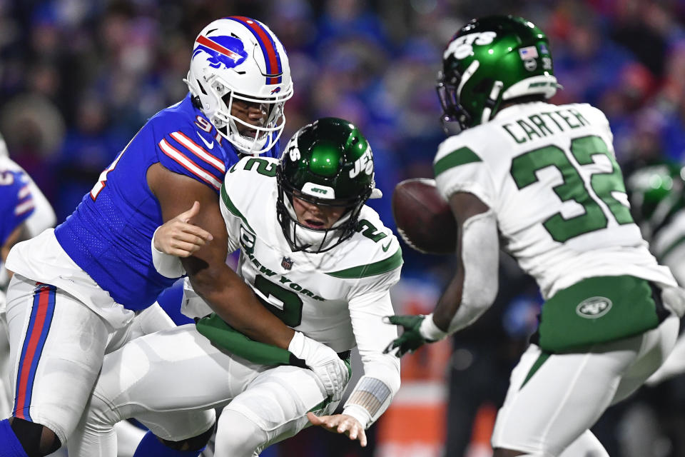 Buffalo Bills' Ed Oliver, left, knocks the ball out of New York Jets quarterback Zach Wilson's hands during the first half of an NFL football game, Sunday, Jan. 9, 2022, in Orchard Park, N.Y. (AP Photo/Adrian Kraus)