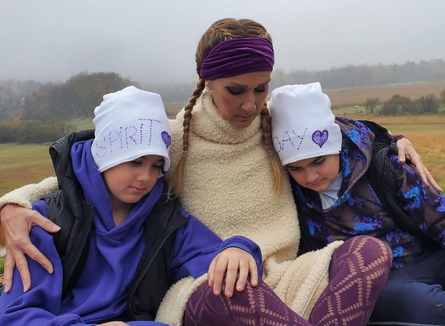 Three people wearing purple