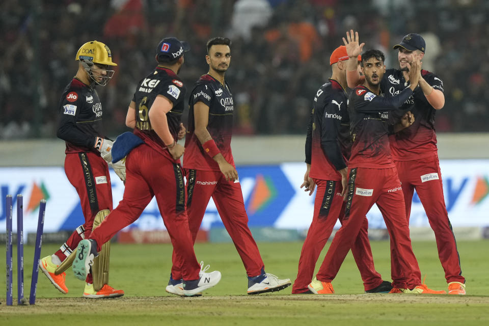 Royal Challengers Bangalores' Shahbaz Ahmed, centre, with his teammates celebrate the wicket of Sunrisers Hyderabads' Aiden Markram during the Indian Premier League cricket match between Sunrisers Hyderabad and Royal Challengers Bangalore in Hyderabad, India, Thursday, May 18, 2023. (AP Photo/Mahesh Kumar A.)