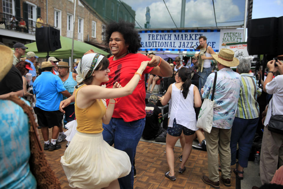 The dance floor is full as Tuba Skinny performs at the French Market Traditional Jazz Stage during the French Quarter Festival on Sunday April 13, 2014. It's been two years since the largest free festival and showcase of Louisiana music, food and culture has taken place in New Orleans' French Quarter. But that changes in April, when the 2022 French Quarter Festival returns. The coronavirus pandemic forced organizers to cancel the event in 2020 and last year. (Kathleen Flynn/The Times-Picayune/The New Orleans Advocate via AP)