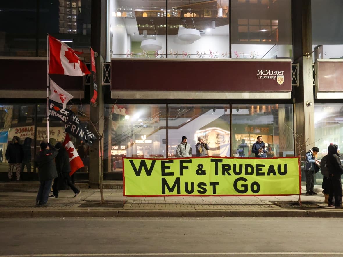 A group of protesters gathered outside the Hamilton conference centre where Prime Minister Justin Trudeau and his cabinet have been meeting. (Supplied by Zimo Wang - image credit)