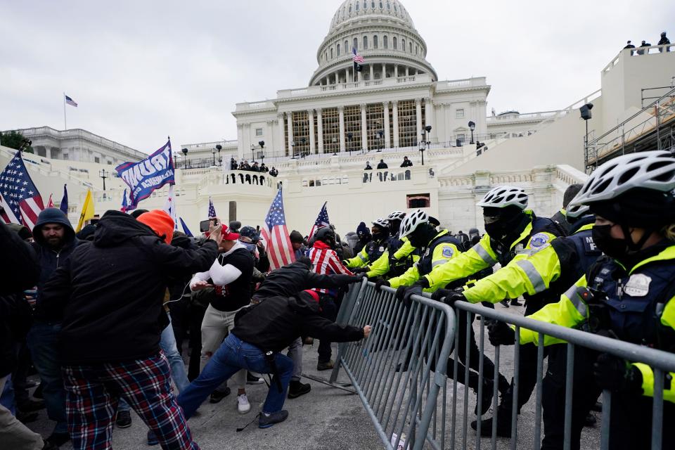 Supporters of then-President Donald Trump try to break through a police barrier at the Capitol in Washington on Jan. 6, 2021.