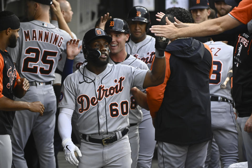 Detroit Tigers left fielder Akil Baddoo (60) celebrates with teammates after scoring during the second inning of a baseball game against the Chicago White Sox, Saturday, Aug. 13, 2022, in Chicago. (AP Photo/Matt Marton)