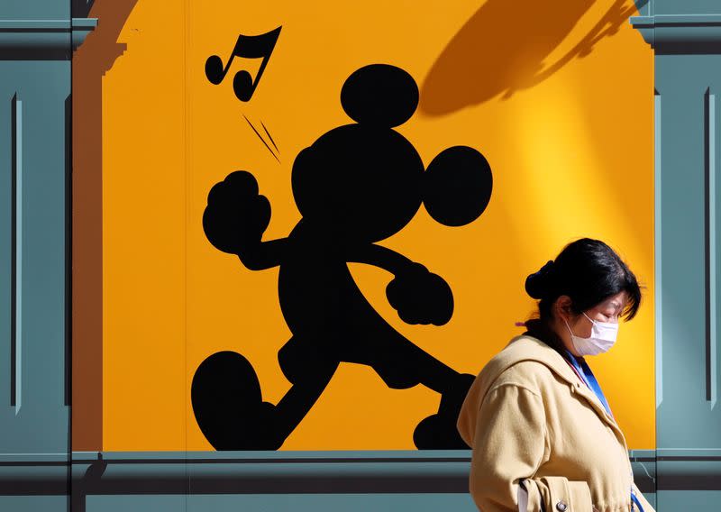 A visitor wearing protective face mask, following an outbreak of the coronavirus, is seen outside Tokyo Disneyland in Urayasu