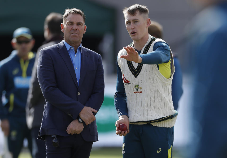 Shane Warne (pictured left) works with Marnus Labuschagne (pictured right)  on his bowling during day two of the 4th Specsavers Test between England and Australia at Old Trafford on September 05, 2019 in Manchester, England.