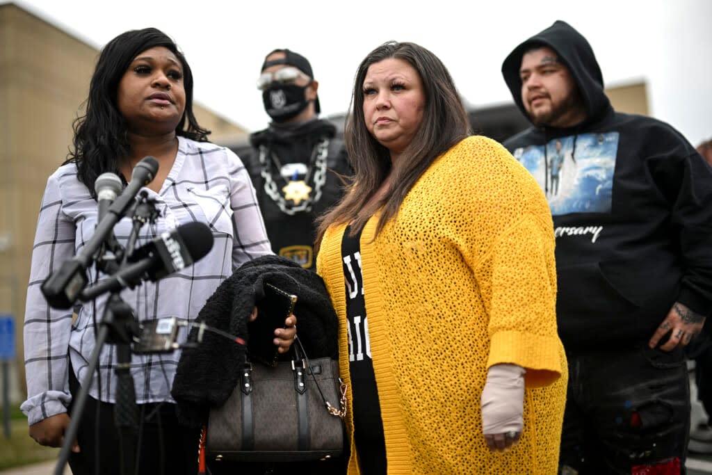 Katie Wright, center, stands beside activist Toshira Garraway and her son, Damik Bryant, during a news conference Thursday, May 5, 2022 outside the Brooklyn Center Police Station in Brooklyn Center, Minn. (Aaron Lavinsky /Star Tribune via AP)