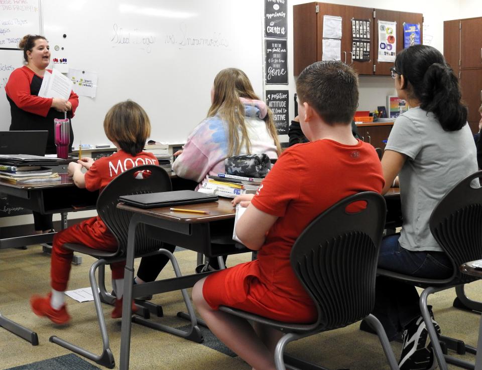 Intervention specialist Samantha Rotruck explains to a sixth grade Coshocton Elementary English class the article they're going to read and then write an essay from. The goal is to compare sled dogs to snow mobiles as part of a unit on the Iditarod Sled Dog Race. The article was scaled for different reading levels by using AI.