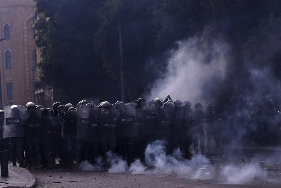 Lebanese riot policemen clash with anti-government protesters during ongoing protests against the Lebanese government, in downtown Beirut, Lebanon, Saturday, June 6, 2020. Hundreds of Lebanese demonstrators gathered in central Beirut Saturday, hoping to reboot nationwide anti-government protests that began late last year amid an unprecedented economic and financial crisis. (AP Photo/Bilal Hussein)