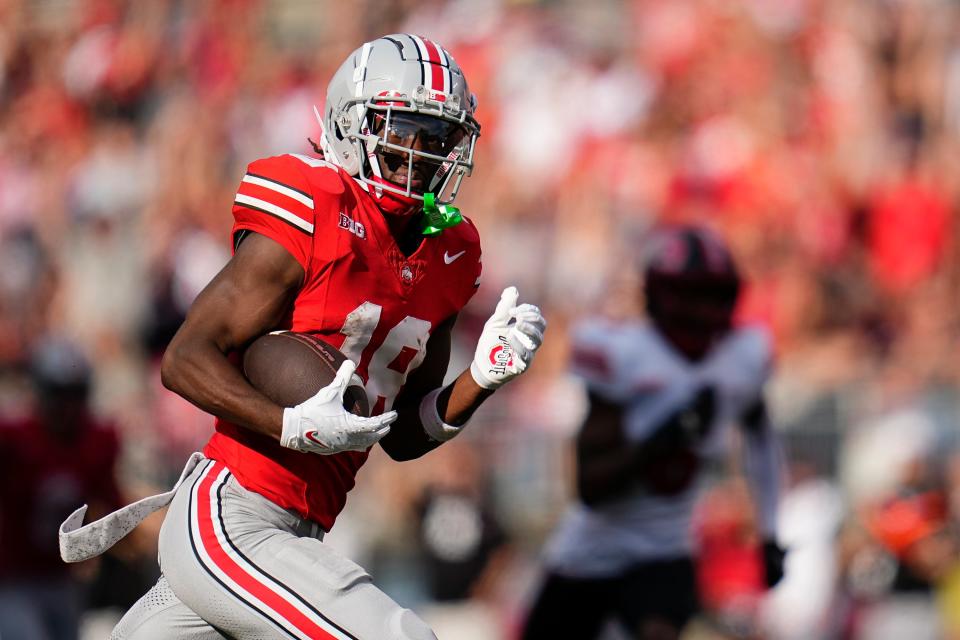 Sep 16, 2023; Columbus, Ohio, USA; Ohio State Buckeyes wide receiver Marvin Harrison Jr. (18) runs for a touchdown during the NCAA football game against the Western Kentucky Hilltoppers at Ohio Stadium. Ohio State won 63-10.