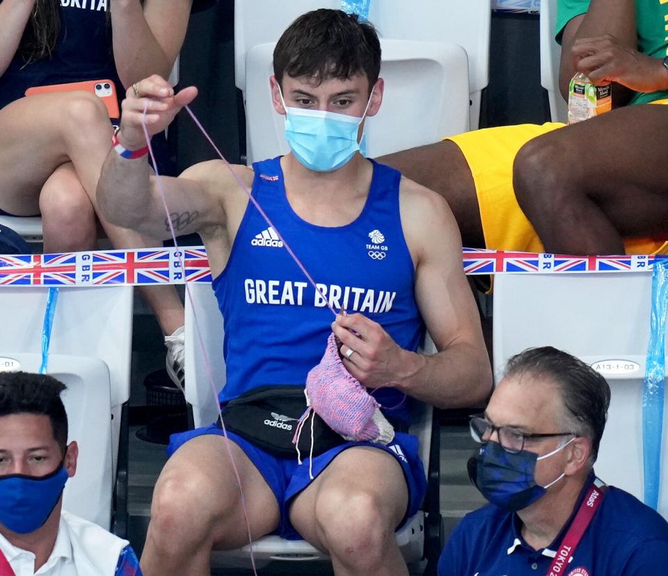 Great Britain's Tom Daley knits in the stands during the Women's 3m Springboard Final at the Tokyo Aquatics Centre on the ninth day of the Tokyo 2020 Olympic Games in Japan. Picture date: Sunday August 1, 2021.
