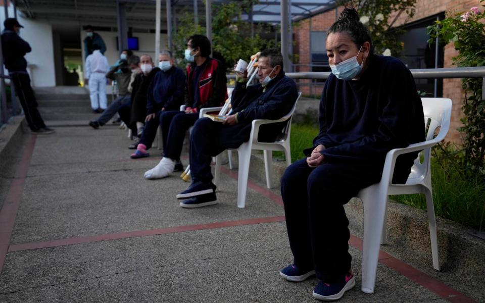 Homeless people wait to get a dose of the Johnson & Johnson Covid-19 vaccine in Bogota, Colombia on 2 July 2021 - Fernando Vergara/AP